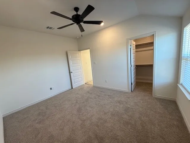 a view of a livingroom with a ceiling fan and window