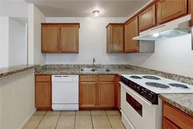 a kitchen with a refrigerator a sink and cabinets