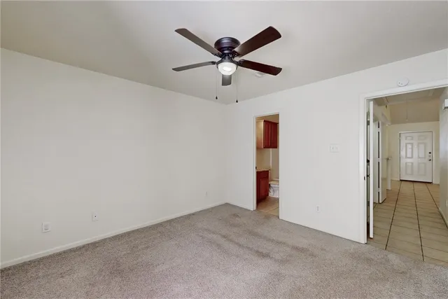 a view of empty room with ceiling fan
