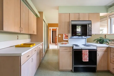 a kitchen with granite countertop a stove and a sink