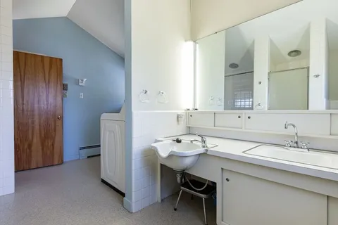 a utility room with cabinets washer and dryer