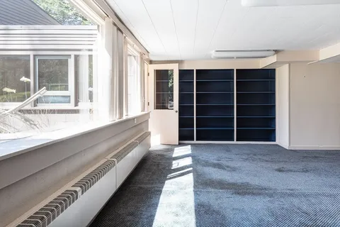 a view of an empty room with a large window