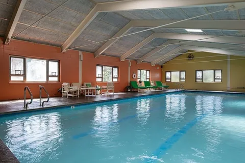 a view of swimming pool with outdoor seating