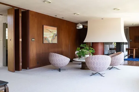 a living room with furniture and a lamp