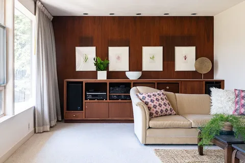 a living room with furniture and wooden floor