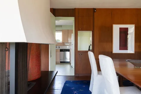 a view of a hallway with furniture and wooden floor