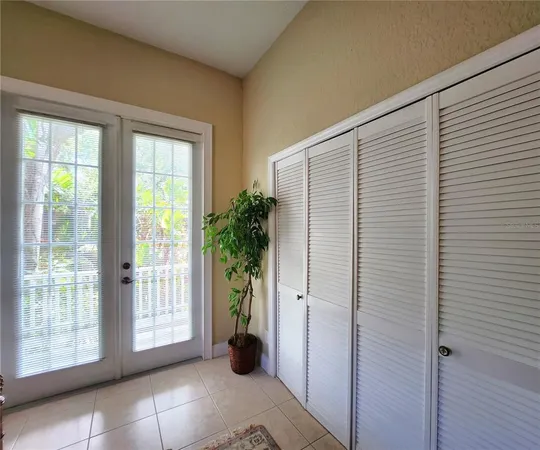 a large kitchen with kitchen island granite countertop lots of white cabinets a dining table and chairs