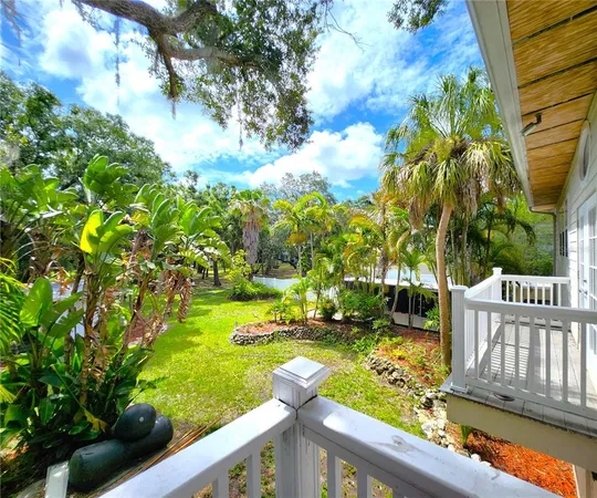 a large kitchen with stainless steel appliances kitchen island granite countertop a large counter top stove a sink dishwasher a dining table and chairs with wooden floor