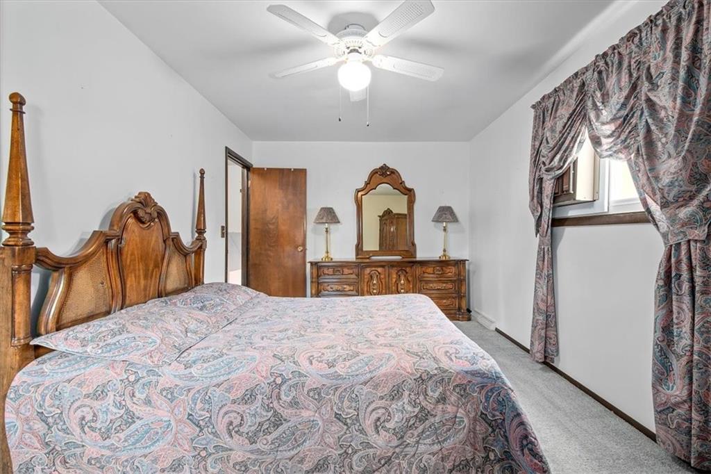 756 Charles Street Rochester, PA 15074 - Photo 13 of 25 a bedroom with a bed and a chandelier