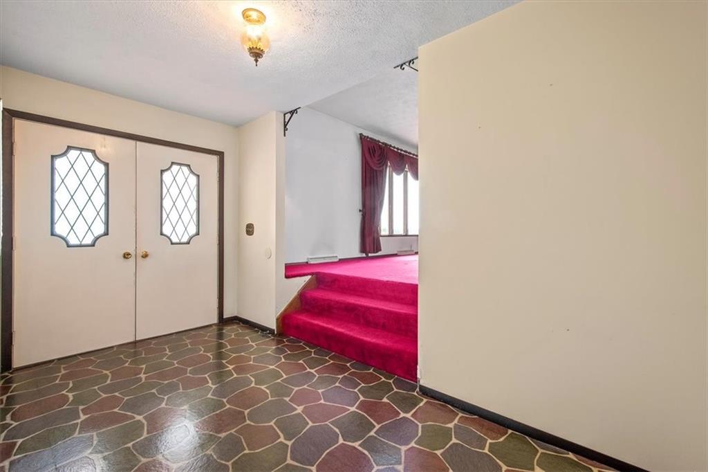 756 Charles Street Rochester, PA 15074 - Photo 3 of 25 a bedroom with a bed and a chandelier