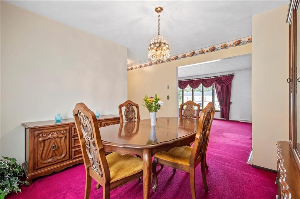 756 Charles Street Rochester, PA 15074 - Photo 6 of 25 a dining room with furniture a chandelier and wooden floor