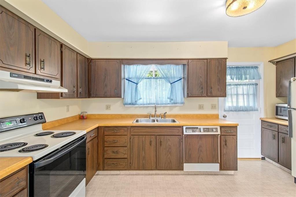 756 Charles Street Rochester, PA 15074 - Photo 9 of 25 a kitchen with stainless steel appliances granite countertop a sink stove and cabinets
