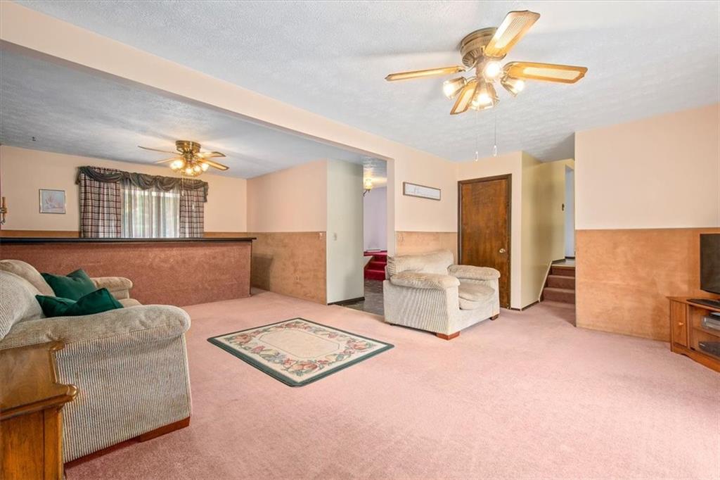 756 Charles Street Rochester, PA 15074 - Photo 10 of 25 a living room with furniture and a chandelier