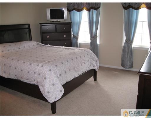 105 Autumn Road Old Bridge, NJ 07747 - Photo 12 of 16 a bedroom with a bed and a television