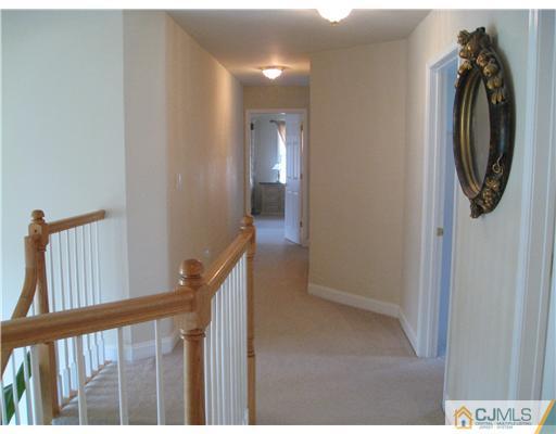 105 Autumn Road Old Bridge, NJ 07747 - Photo 16 of 16 a view of a hallway with washer and dryer