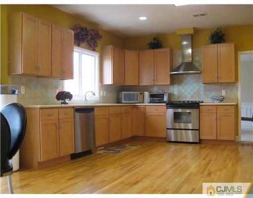 105 Autumn Road Old Bridge, NJ 07747 - Photo 4 of 16 a kitchen with a sink window and cabinets