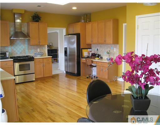 105 Autumn Road Old Bridge, NJ 07747 - Photo 5 of 16 a kitchen with stainless steel appliances granite countertop a stove a refrigerator a sink a stove and a microwave