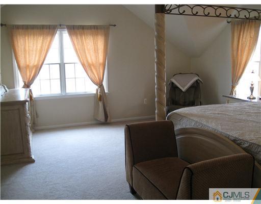 105 Autumn Road Old Bridge, NJ 07747 - Photo 9 of 16 a bedroom with a bed and a window