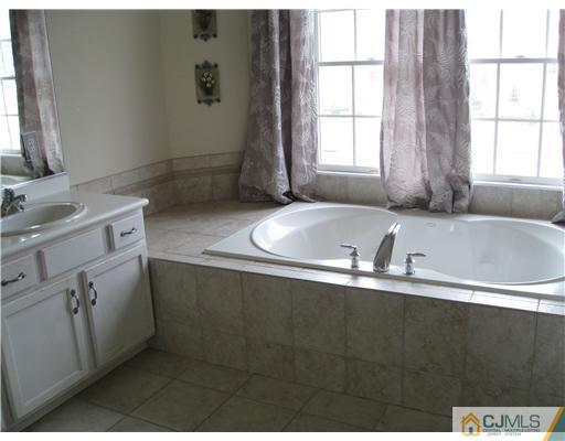 105 Autumn Road Old Bridge, NJ 07747 - Photo 10 of 16 a bathroom with a sink and a bathtub