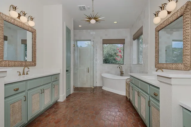 a bathroom with a double vanity sink a toilet a mirror and shower