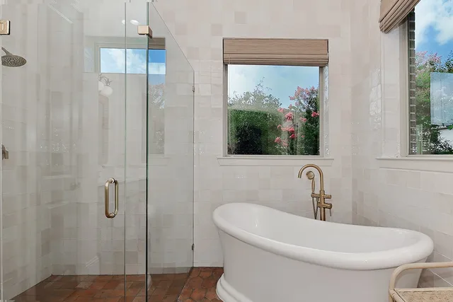 a white bath tub sitting next to a white toilet