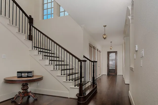 a view of entryway and hall with wooden floor