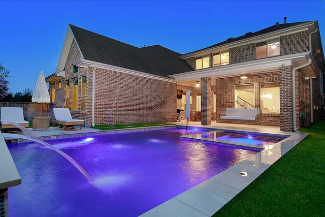 a view of pool with lawn chairs and floor to ceiling window