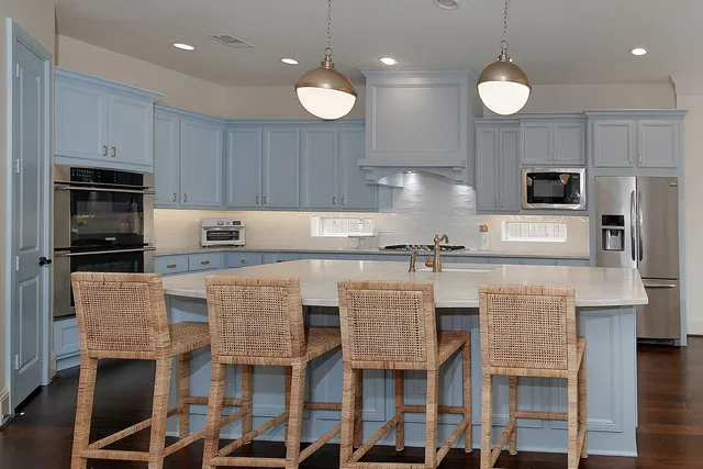 a kitchen with cabinets and stainless steel appliances