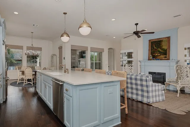 a kitchen with sink cabinets and wooden floor