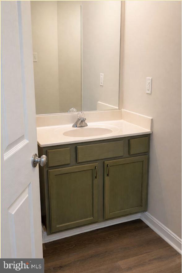 8801 Stoneridge Circle, Unit T2 Baltimore, MD 21208 - Photo 15 of 24 a bathroom with a sink and a mirror