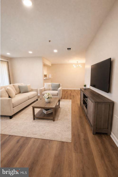 8801 Stoneridge Circle, Unit T2 Baltimore, MD 21208 - Photo 9 of 24 a living room with furniture and a flat screen tv