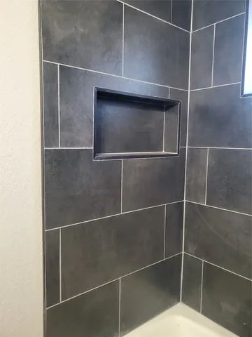 a bathroom with a mirror and a shower
