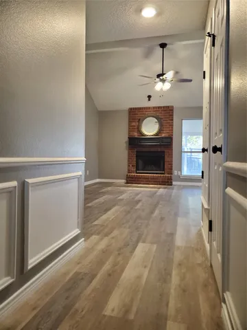 a view of a hallway with wooden floor
