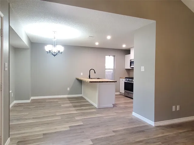 a view of a kitchen with marble kitchen and refrigerator
