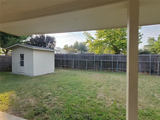a view of a wooden house with a yard