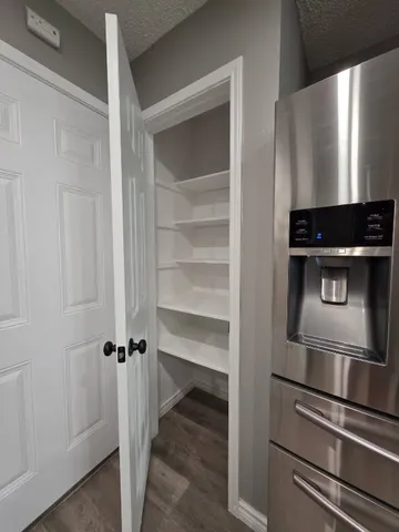 a view of a room with wooden floor