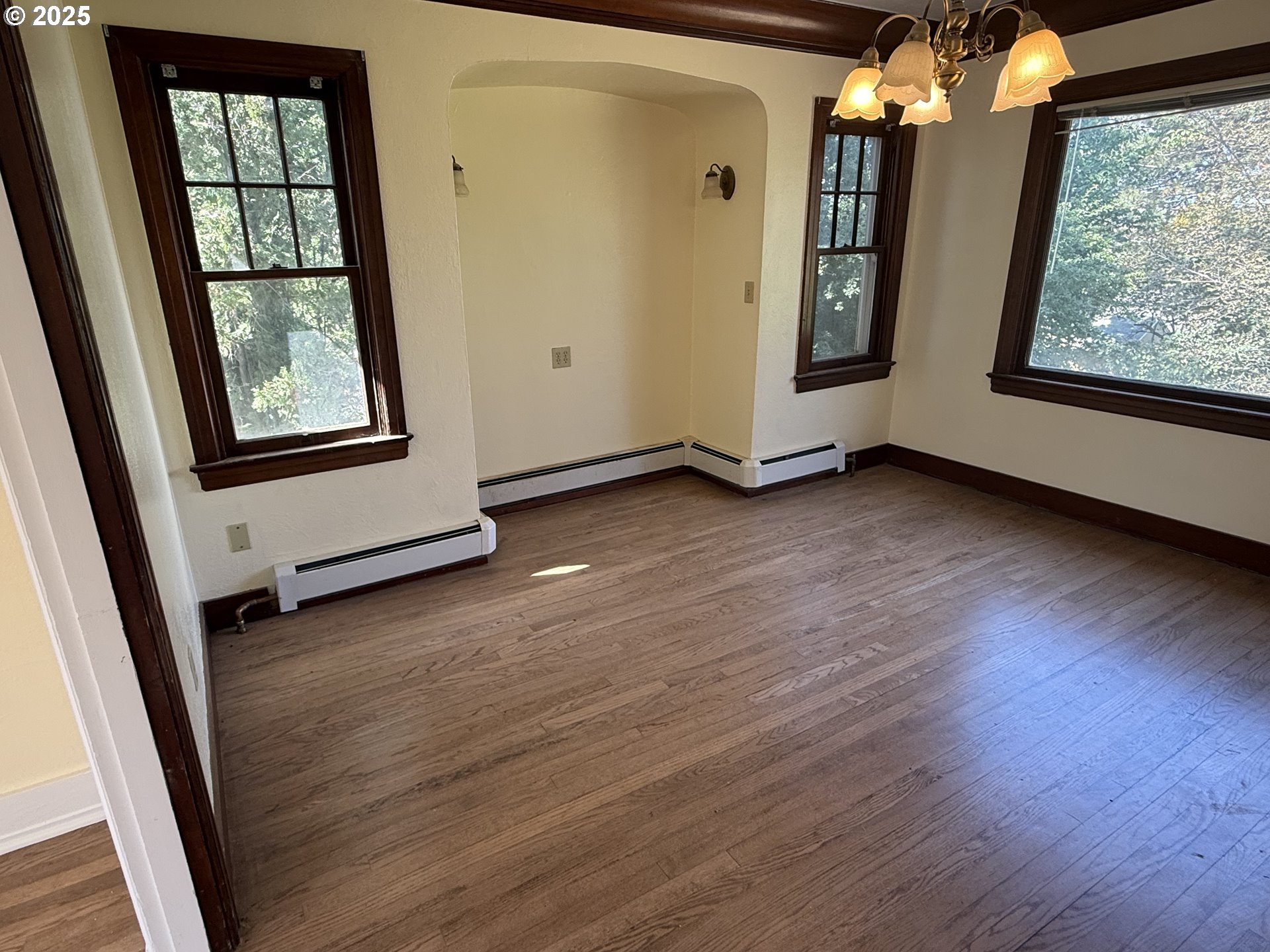311 Northwest 11th Street Pendleton, OR 97801 - Photo 5 of 11 an empty room with wooden floor and windows