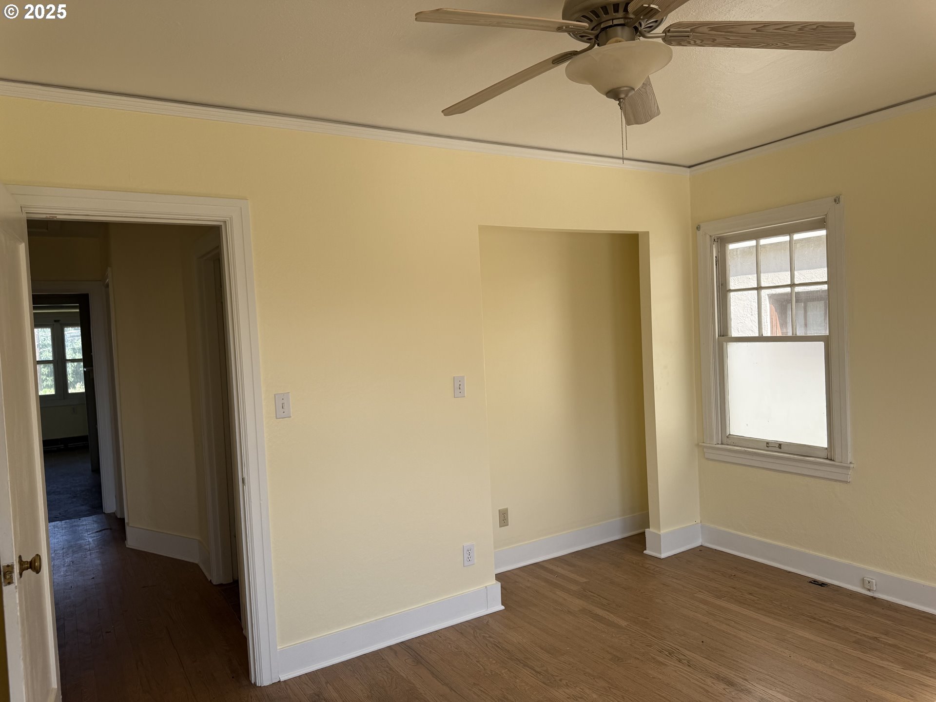 311 Northwest 11th Street Pendleton, OR 97801 - Photo 8 of 11 a view of an empty room with a window and wooden floor