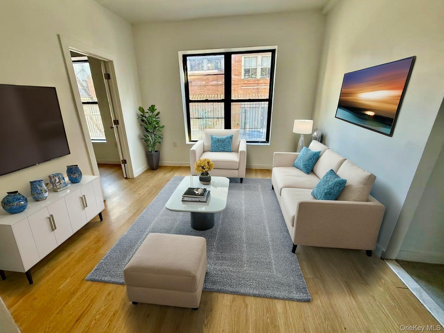 Living room with light wood-type flooring and healthy amount of natural light