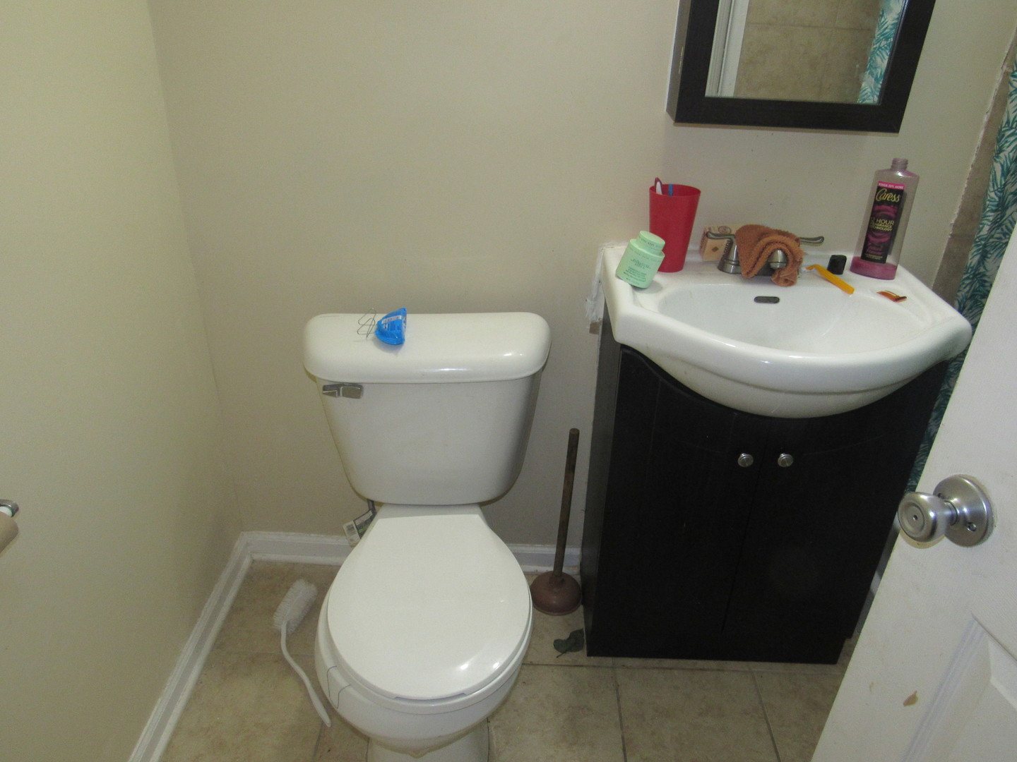 1132 East 81st Street, Unit H Chicago, IL 60619 - Photo 9 of 19 a bathroom with a toilet sink and mirror