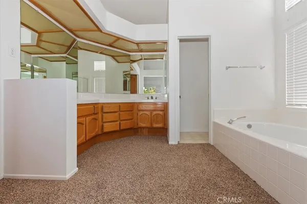 a view of an empty room with closet and a window