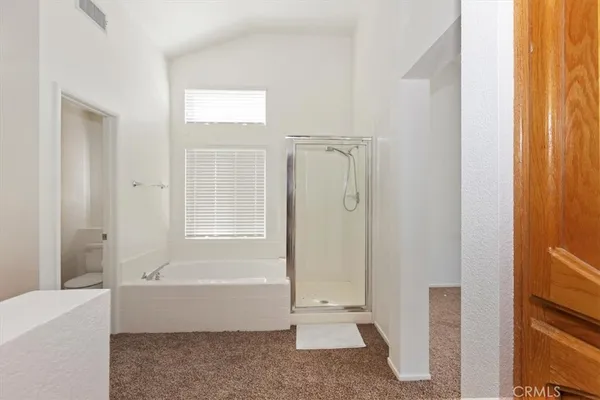 a spacious bathroom with a granite countertop sink a mirror and a shower