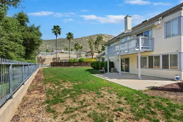 an aerial view of a house with a garden and lake view