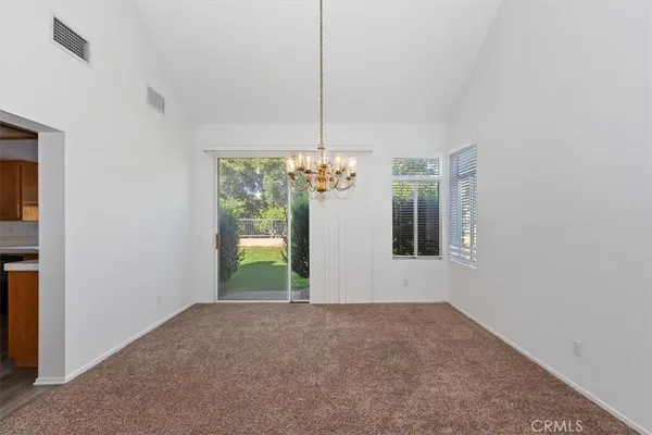 a view of staircase with lots of frames on wall and windows