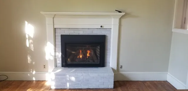 a view of fireplace and wooden floor