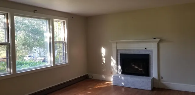 a living room with a fireplace and a fireplace