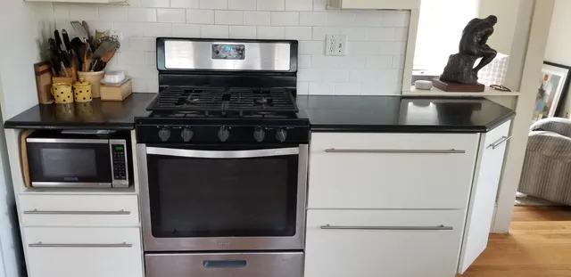 a view of a room with wooden floor and a window