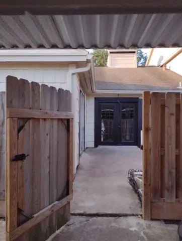 a outdoor view of house with wooden fence