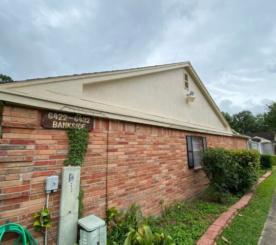6432 Bankside Drive Houston, TX 77096 - Photo 2 of 14 a backyard of a house with plants and outdoor seating