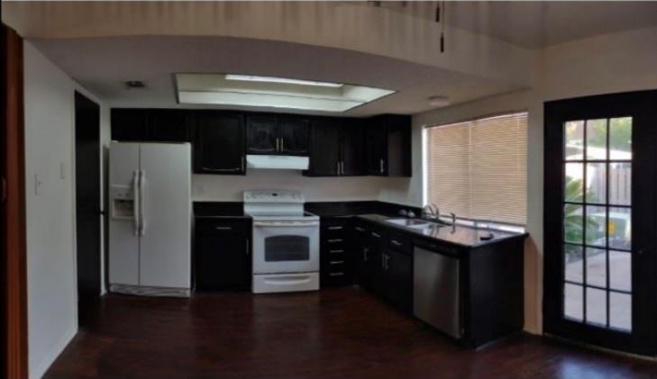 6432 Bankside Drive Houston, TX 77096 - Photo 5 of 14 a kitchen with stainless steel appliances granite countertop a refrigerator a sink and a stove